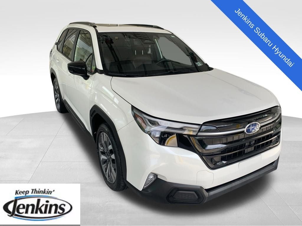 2025 Subaru Forester Touring in Crystal White Pearl — front three-quarter view